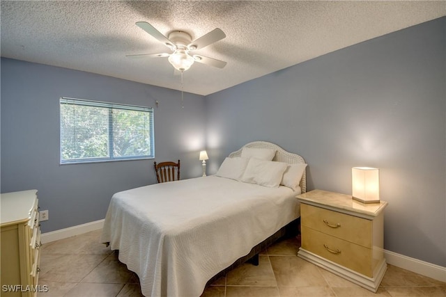 tiled bedroom featuring ceiling fan and a textured ceiling