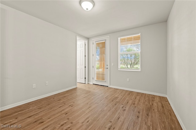 empty room with light hardwood / wood-style flooring