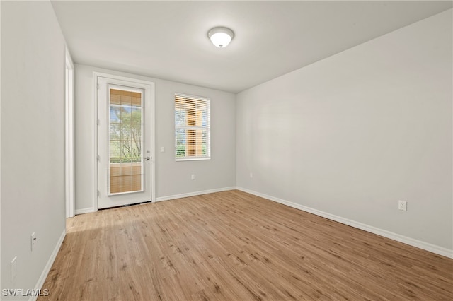 spare room with light wood-type flooring