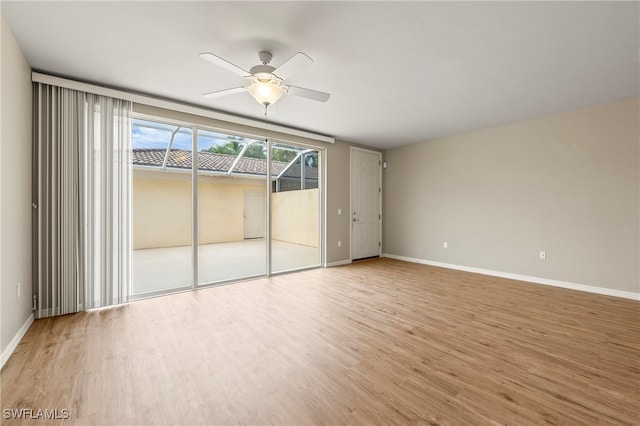 empty room with ceiling fan and light wood-type flooring