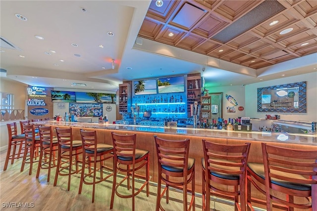 bar with light hardwood / wood-style flooring