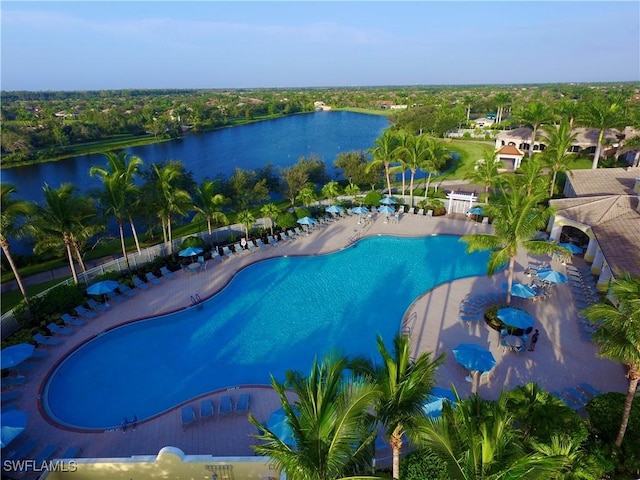 view of swimming pool featuring a water view and a patio