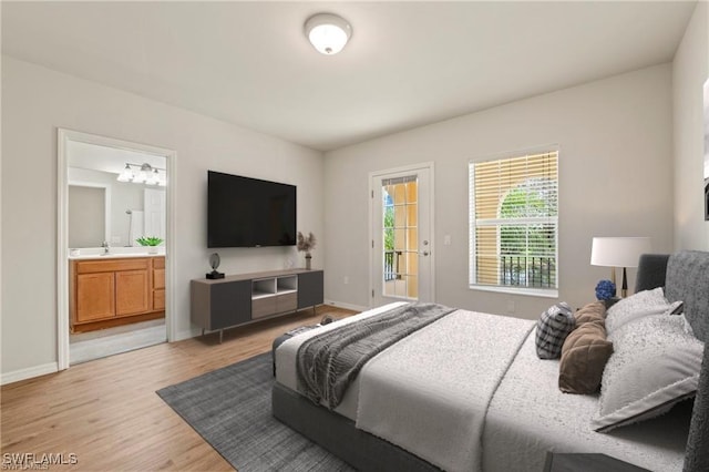 bedroom featuring light hardwood / wood-style floors, access to exterior, and connected bathroom