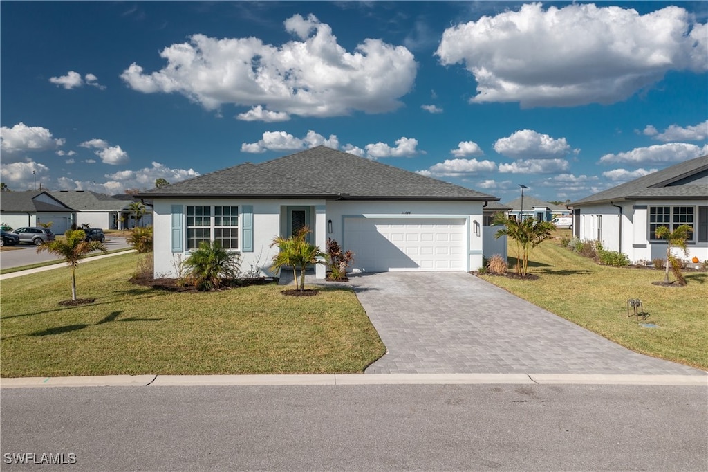 view of front of home with a front yard and a garage