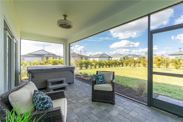 sunroom with a hot tub