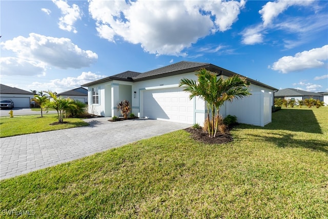 single story home featuring a garage and a front lawn