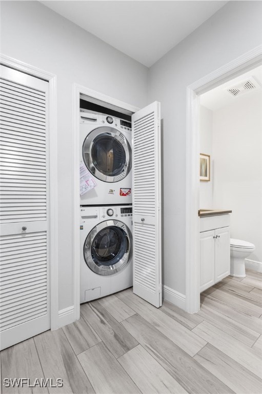 laundry area with stacked washer / dryer