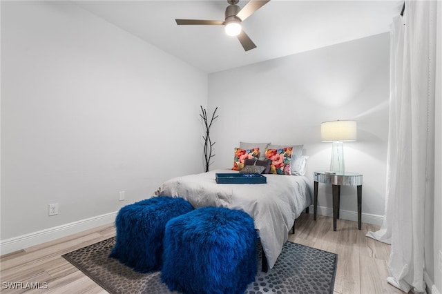 bedroom featuring ceiling fan, vaulted ceiling, and light wood-type flooring