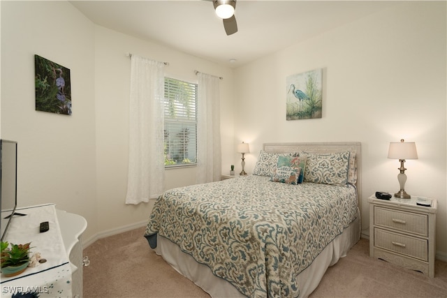 bedroom with ceiling fan and light colored carpet