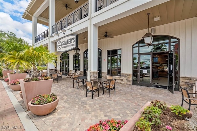 view of patio / terrace with ceiling fan and a balcony