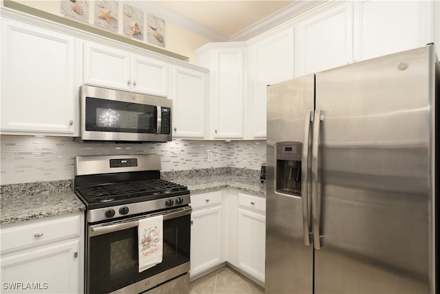 kitchen with white cabinetry, light stone countertops, and stainless steel appliances