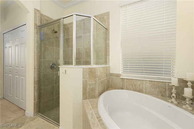 bathroom featuring tile patterned flooring, crown molding, and separate shower and tub