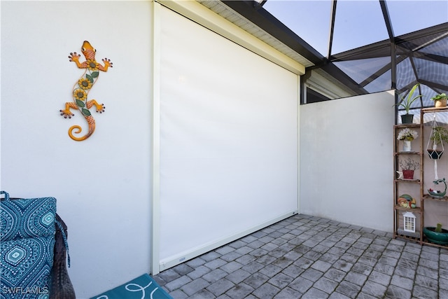 view of patio with glass enclosure