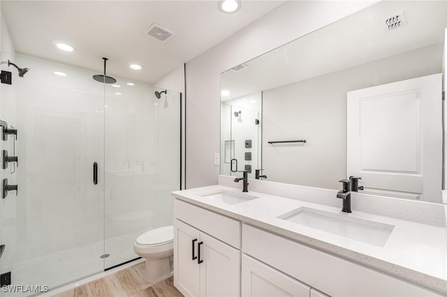 bathroom with a sink, visible vents, and a shower stall