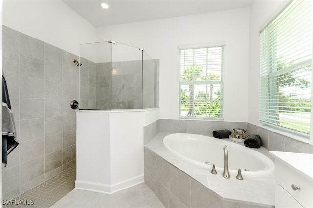 bathroom with tile patterned flooring, a healthy amount of sunlight, and plus walk in shower