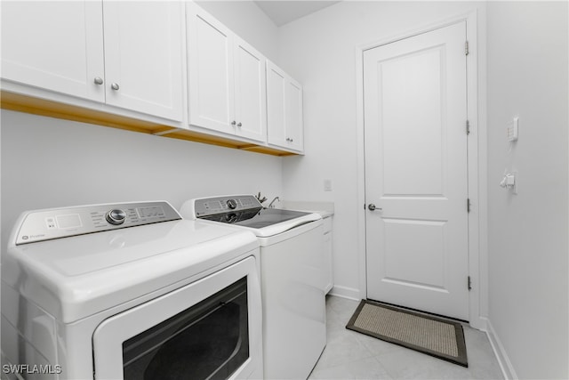 laundry room featuring cabinets and separate washer and dryer