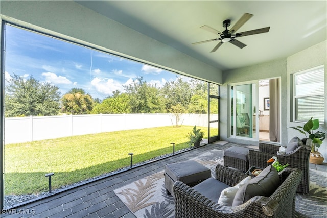 unfurnished sunroom featuring a wealth of natural light and ceiling fan