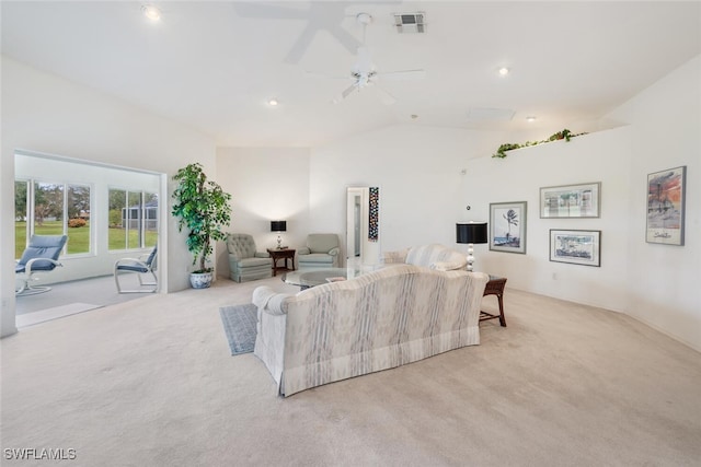 carpeted living room with ceiling fan and vaulted ceiling