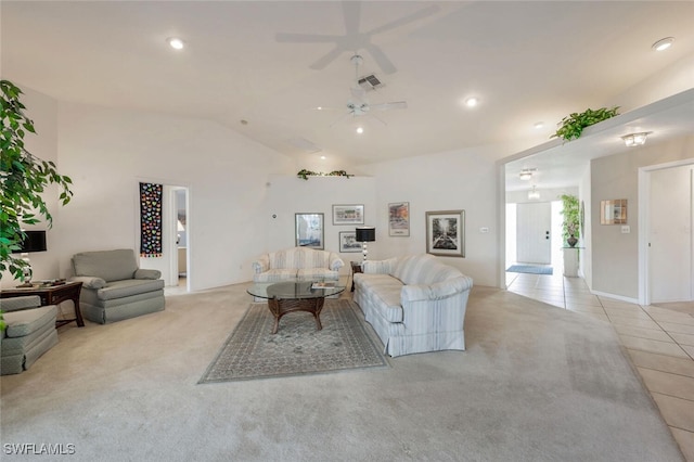 living room with lofted ceiling, light tile patterned floors, and ceiling fan