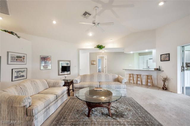 carpeted living room featuring lofted ceiling and ceiling fan