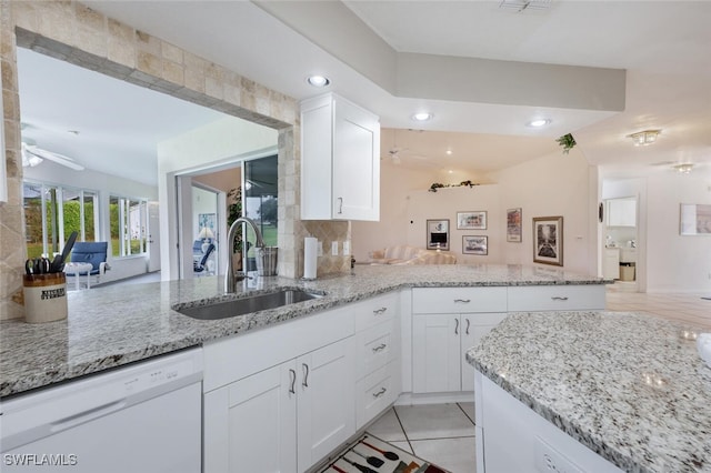 kitchen featuring white cabinets, light stone countertops, sink, and white dishwasher