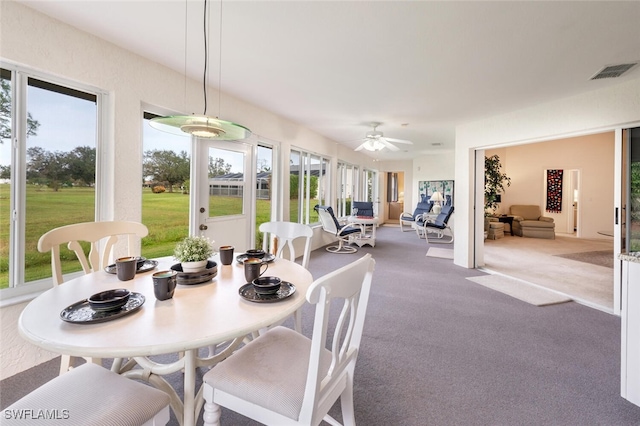 sunroom / solarium featuring ceiling fan and plenty of natural light