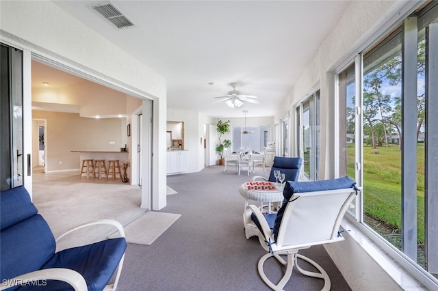 sunroom / solarium with ceiling fan