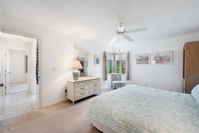 bedroom featuring connected bathroom, ceiling fan, and light colored carpet