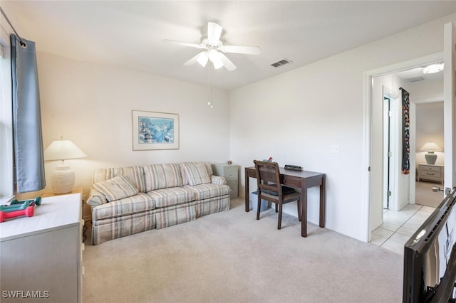 living room with light colored carpet and ceiling fan