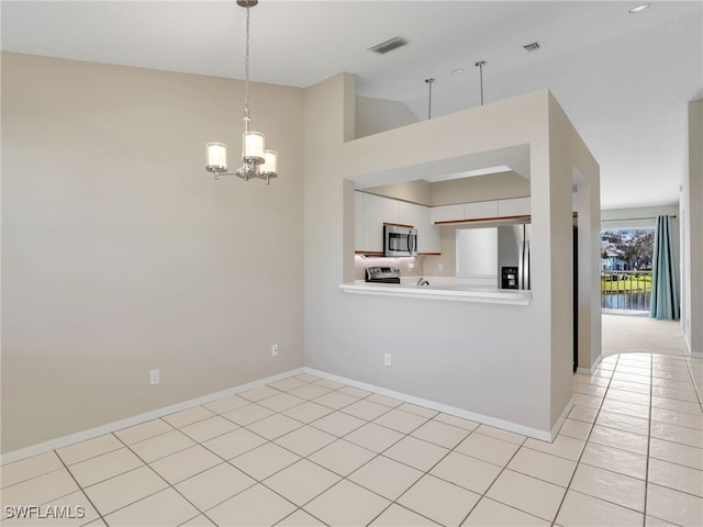 kitchen with high vaulted ceiling, hanging light fixtures, light tile patterned floors, appliances with stainless steel finishes, and a chandelier