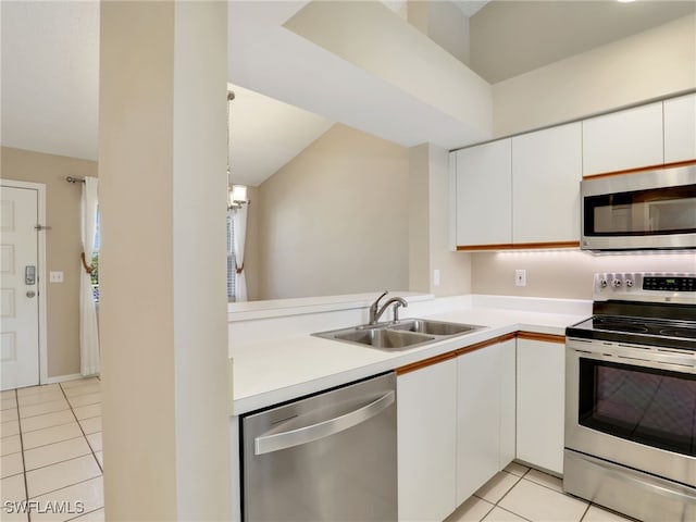 kitchen featuring white cabinets, appliances with stainless steel finishes, light tile patterned flooring, and sink