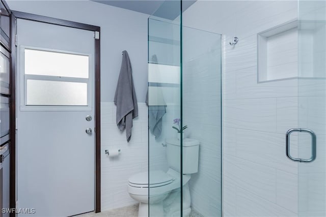 bathroom featuring an enclosed shower and toilet