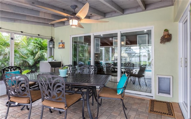 sunroom / solarium featuring beam ceiling, ceiling fan, and wood ceiling