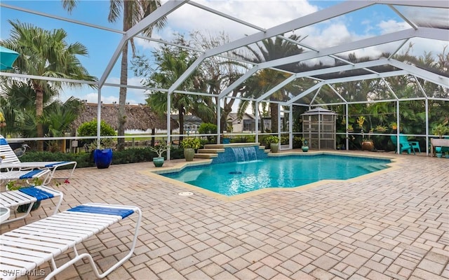 view of swimming pool featuring pool water feature, a lanai, and a patio