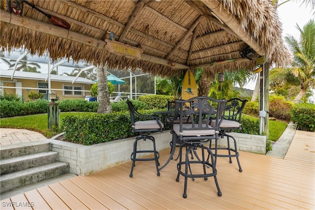 wooden terrace with a gazebo and a lanai