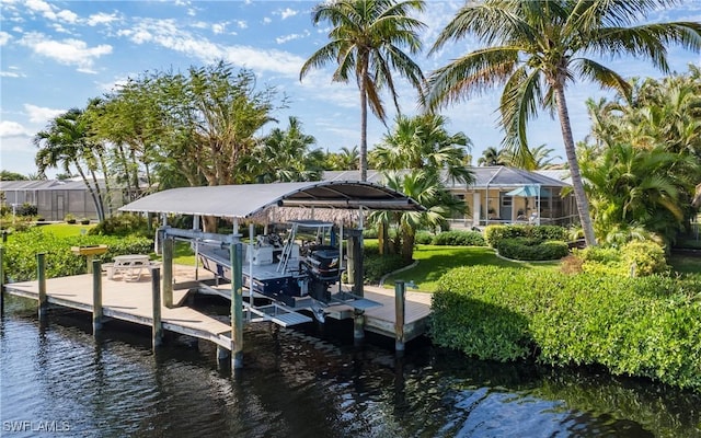 dock area with a lanai and a water view