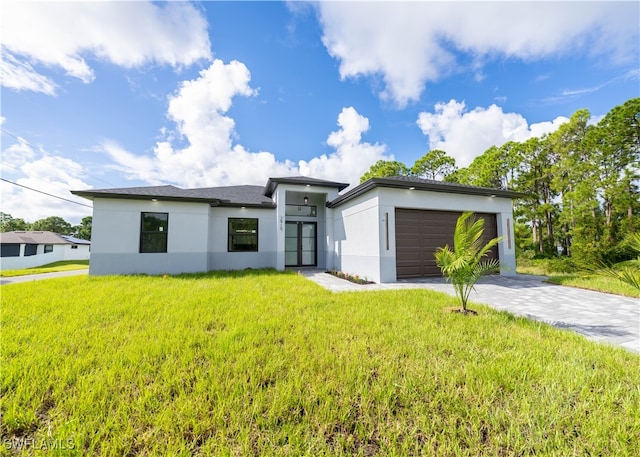 contemporary home with a front yard and a garage