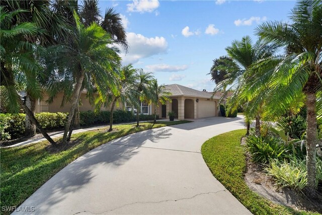 view of front of house with a front lawn and a garage