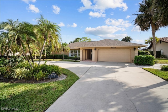 single story home with a garage and a front lawn