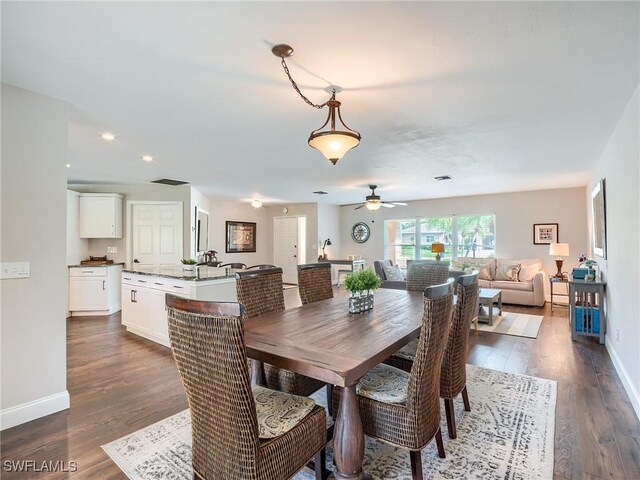 dining area with ceiling fan and dark hardwood / wood-style flooring