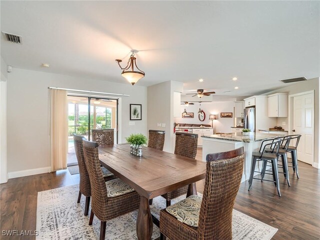 dining space featuring ceiling fan and dark hardwood / wood-style flooring