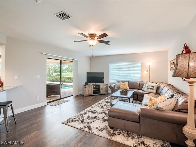 living room with ceiling fan and dark hardwood / wood-style floors