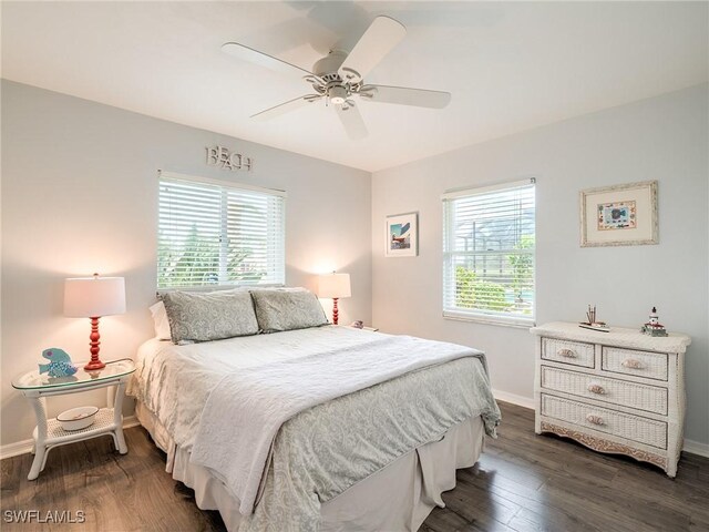 bedroom with ceiling fan and dark hardwood / wood-style flooring