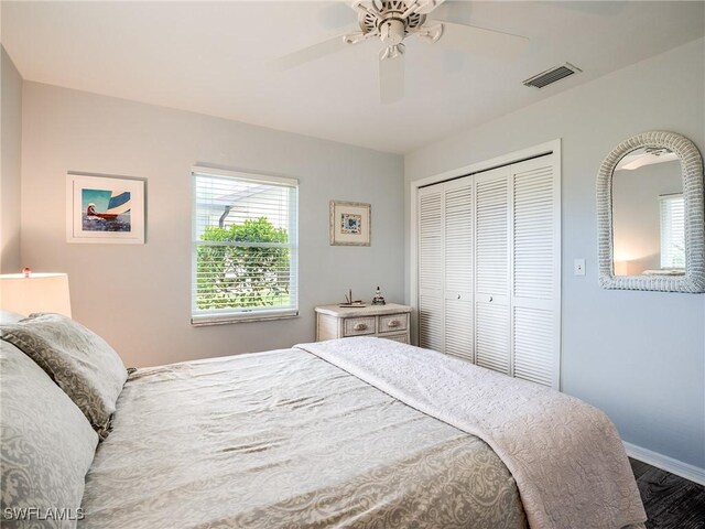 bedroom with a closet, ceiling fan, and dark hardwood / wood-style flooring