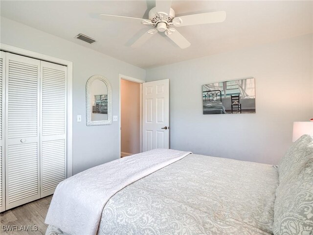 bedroom with a closet, ceiling fan, and light wood-type flooring