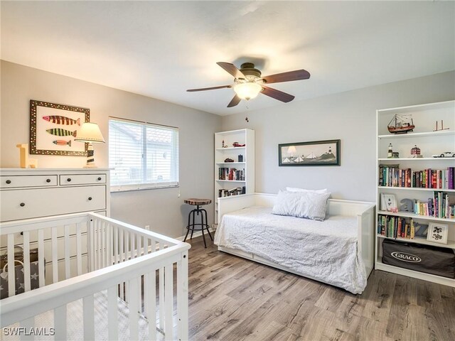 bedroom featuring light wood-type flooring and ceiling fan