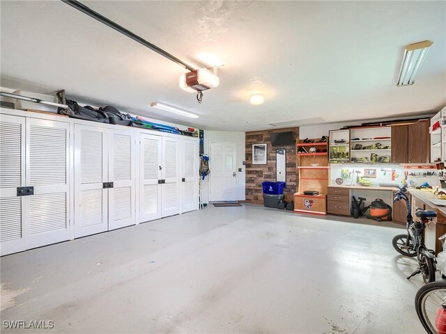 garage with a workshop area and a garage door opener