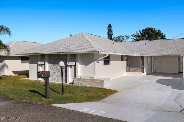 ranch-style home with a front lawn and a carport