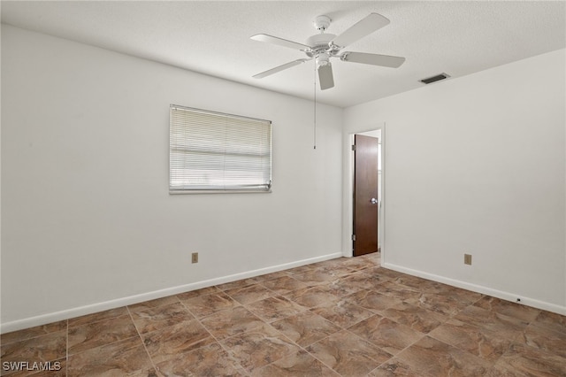 unfurnished room featuring a textured ceiling and ceiling fan