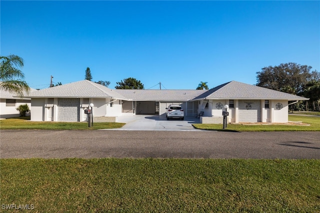 single story home with a front yard and a carport